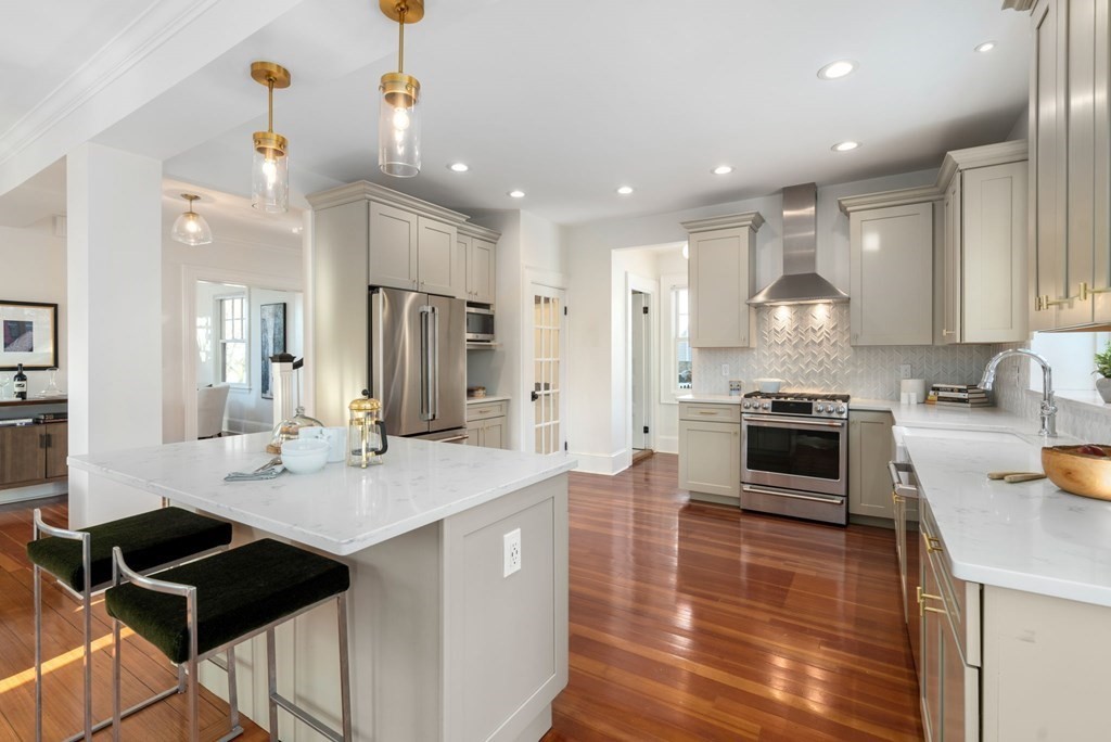 24 Maxfield Street Boston, MA 02132 - Photo 14 of 36 a kitchen with stainless steel appliances kitchen island granite countertop a stove a sink a refrigerator and a cabinets