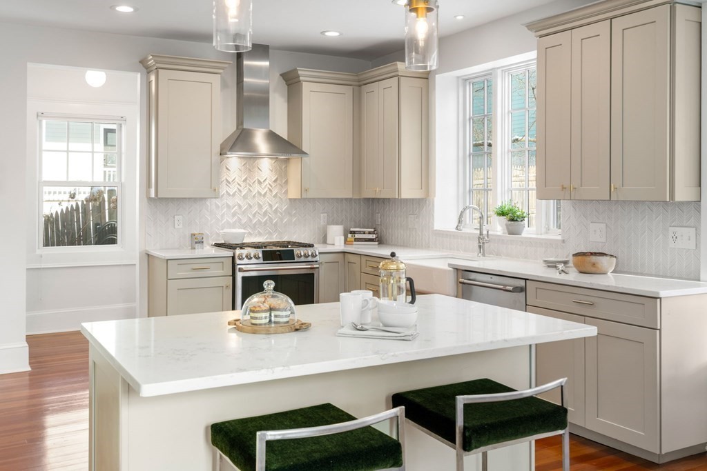 24 Maxfield Street Boston, MA 02132 - Photo 15 of 36 a kitchen with a sink a stove and chairs