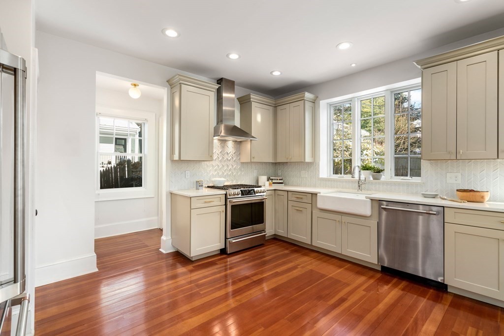 24 Maxfield Street Boston, MA 02132 - Photo 18 of 36 a large kitchen with stainless steel appliances granite countertop a stove and a sink