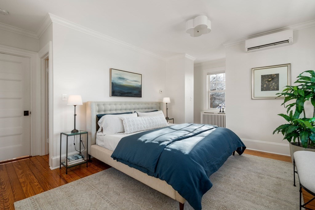 24 Maxfield Street Boston, MA 02132 - Photo 24 of 36 a bedroom with a bed and a potted plant