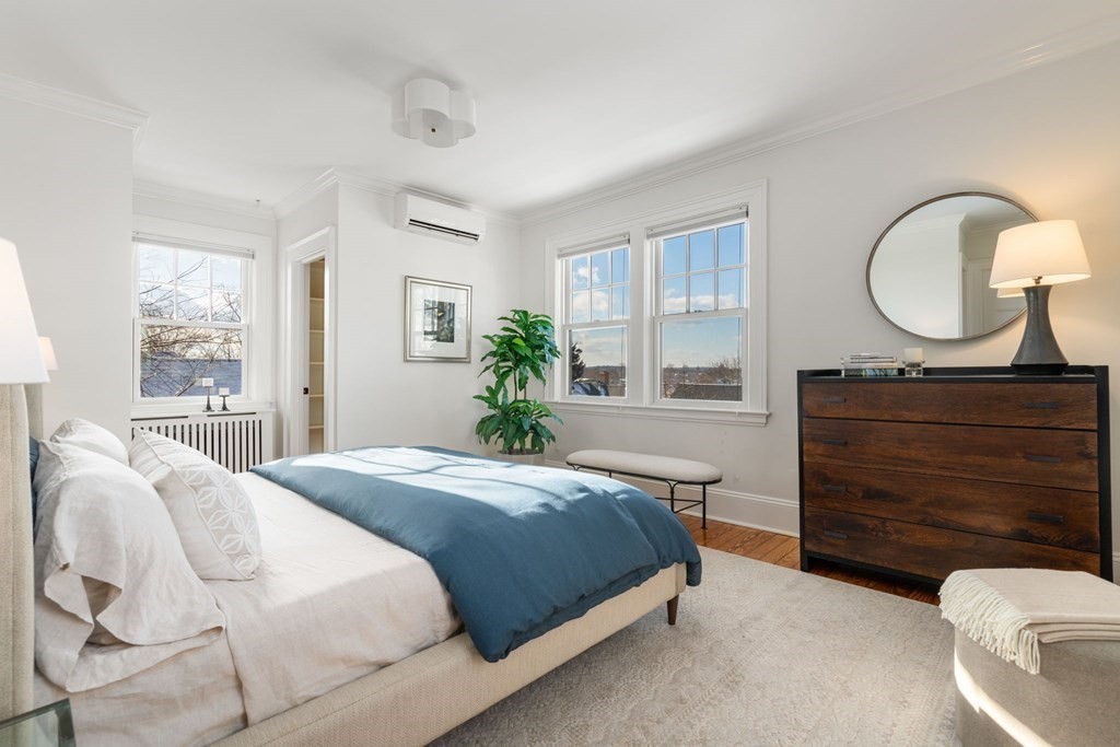 24 Maxfield Street Boston, MA 02132 - Photo 25 of 36 a bedroom with a bed and window with chair