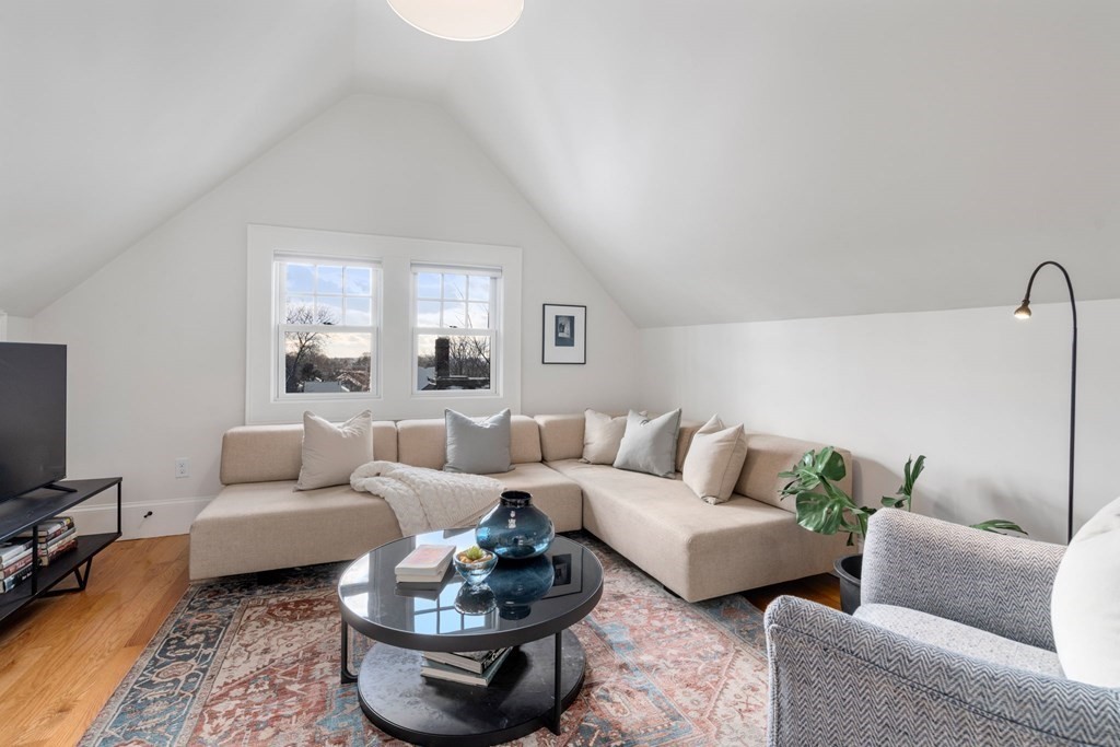 24 Maxfield Street Boston, MA 02132 - Photo 27 of 36 a living room with furniture potted plant and a window