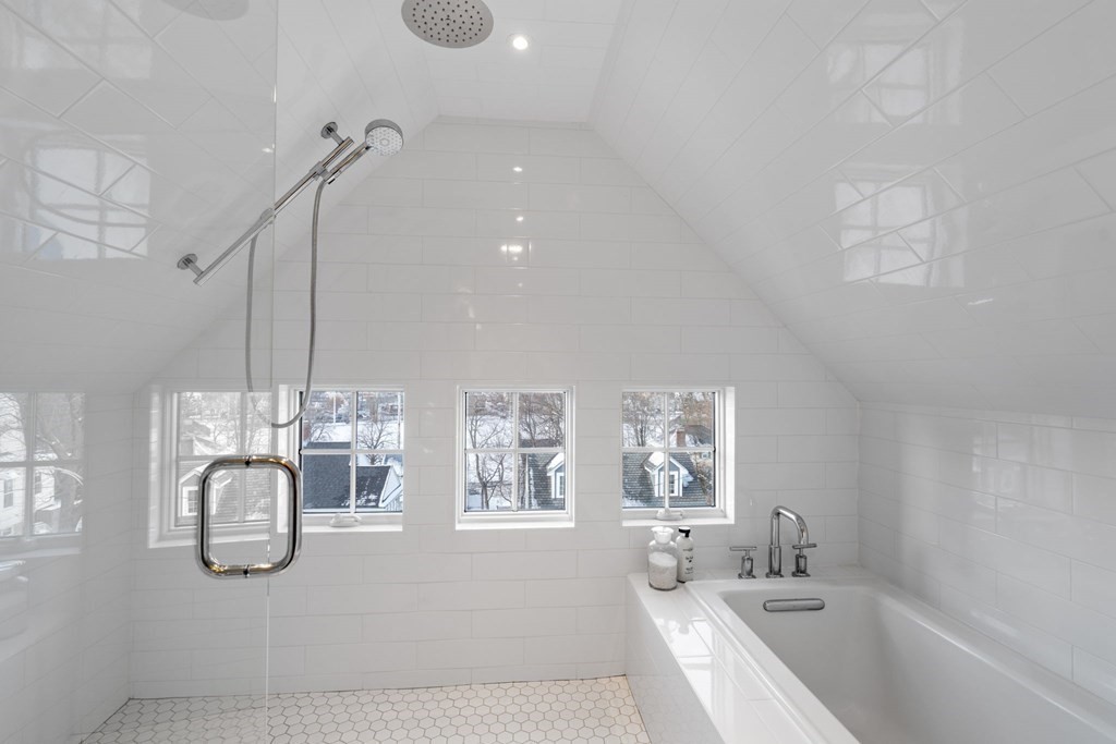 24 Maxfield Street Boston, MA 02132 - Photo 29 of 36 a spacious bathroom with a granite countertop sink a large mirror and shower