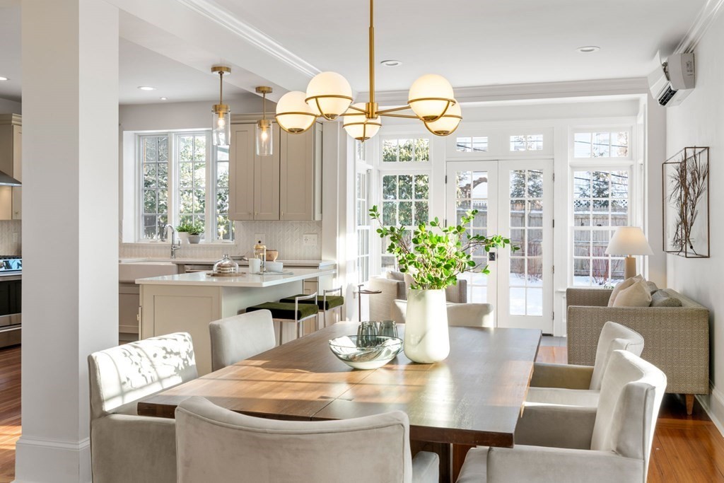 24 Maxfield Street Boston, MA 02132 - Photo 8 of 36 a dining room with furniture a chandelier and wooden floor