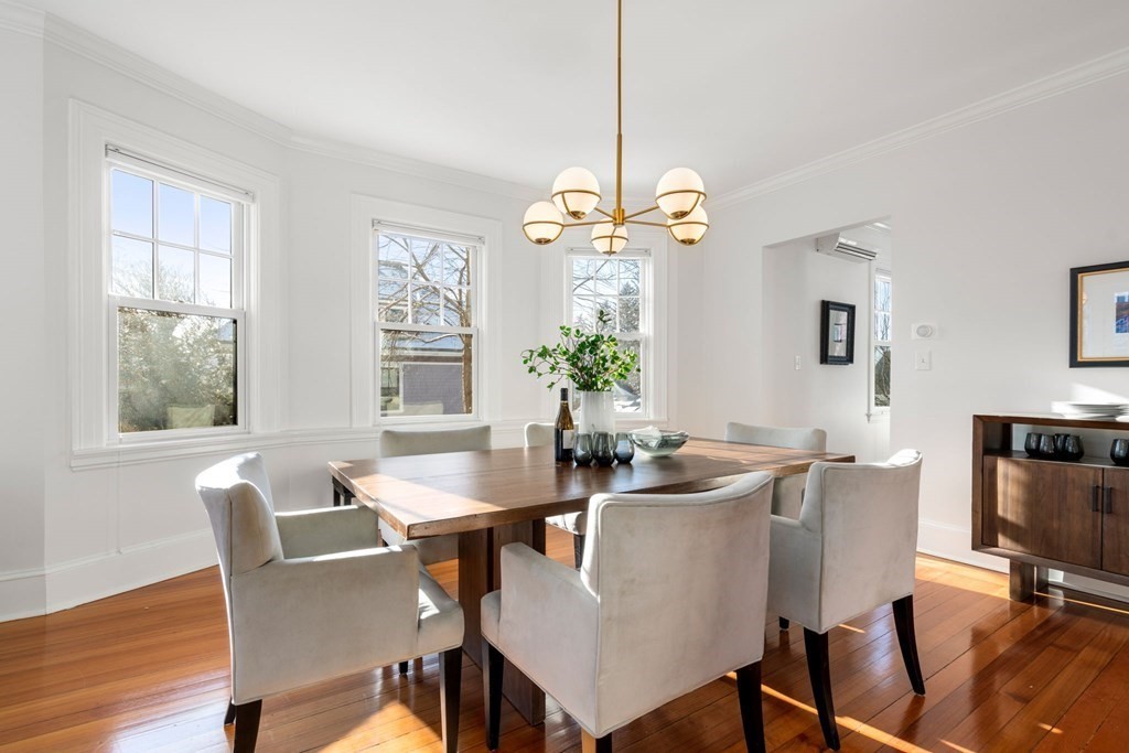24 Maxfield Street Boston, MA 02132 - Photo 10 of 36 a dining room with furniture a chandelier and wooden floor