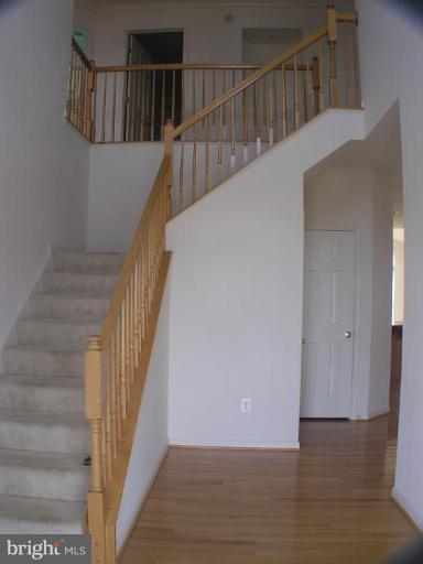 1307 Destrier Street Ranson, WV 25438 - Photo 2 of 15 a view of staircase with wooden floor and white walls