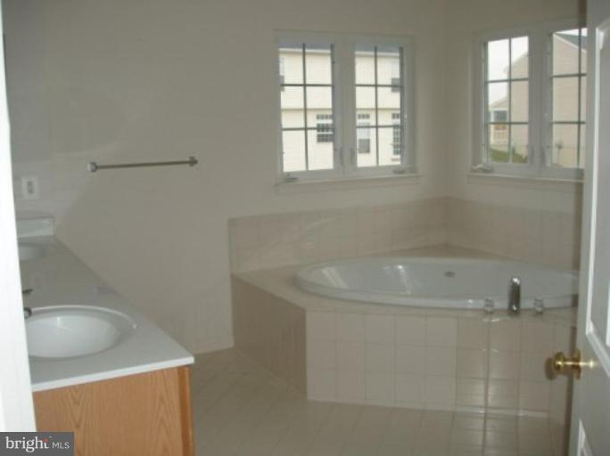 1307 Destrier Street Ranson, WV 25438 - Photo 12 of 15 a bath tub sitting next to a window