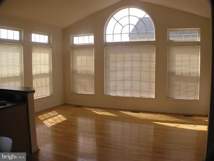 1307 Destrier Street Ranson, WV 25438 - Photo 4 of 15 an empty room with wooden floor and windows