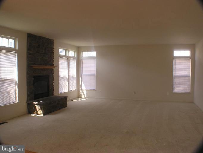 1307 Destrier Street Ranson, WV 25438 - Photo 6 of 15 a view of an empty room with a fireplace