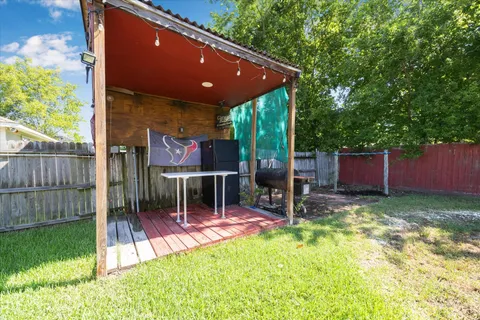 a view of a chairs and table in the backyard