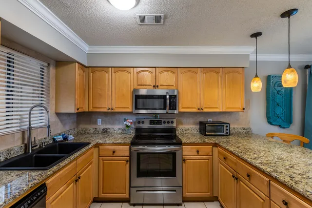 a kitchen with sink refrigerator and cabinets