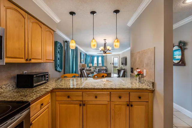 a kitchen with stainless steel appliances granite countertop sink refrigerator and microwave