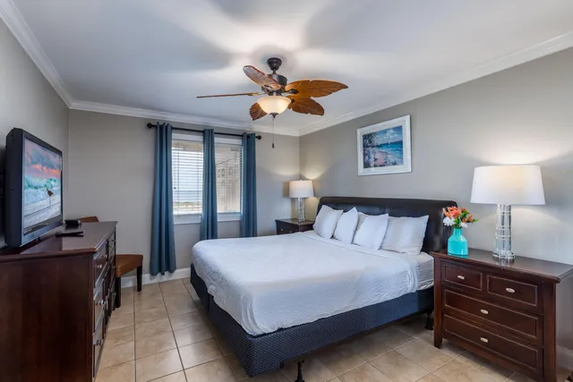 a bedroom with a bed and dresser with mirror