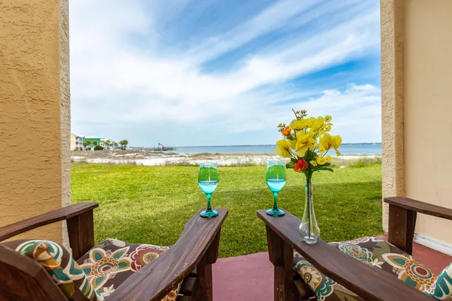 a view of a house with pool and chairs