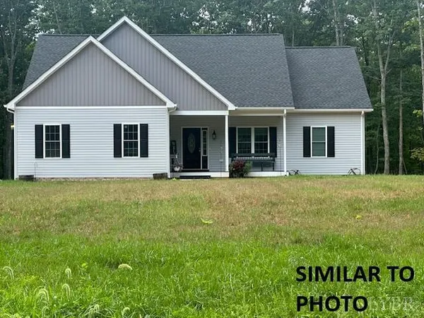 a house with huge green field in front of it