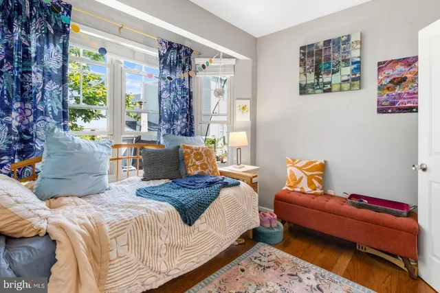 a bedroom with bed and windows