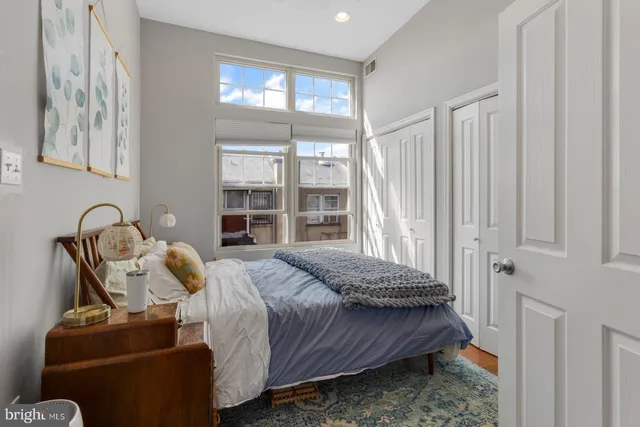 a bedroom with a bed and a window