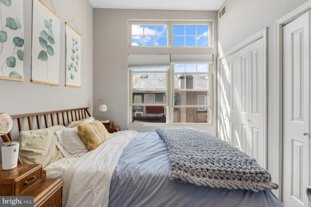 a bedroom with bed and a window