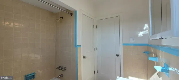 a bathroom with a shower and a tub