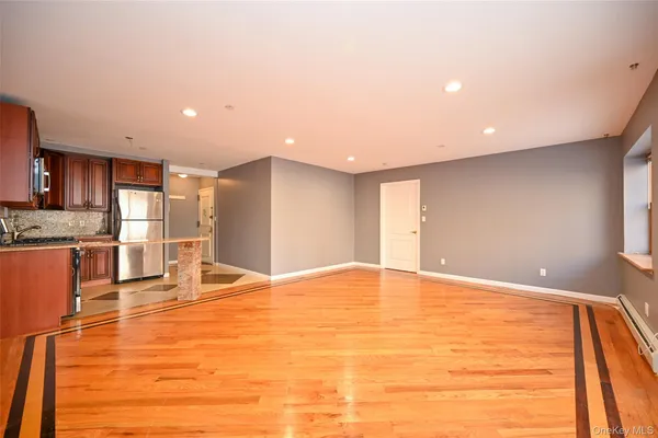 a view of an empty room with kitchen appliances