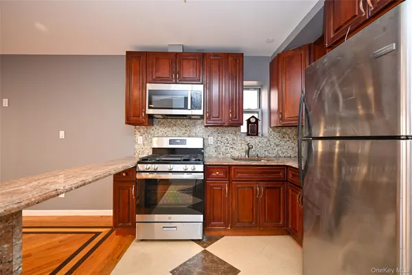 a kitchen with a refrigerator stove and microwave