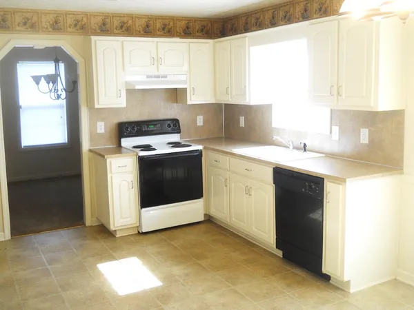 a kitchen with a stove a sink and a microwave