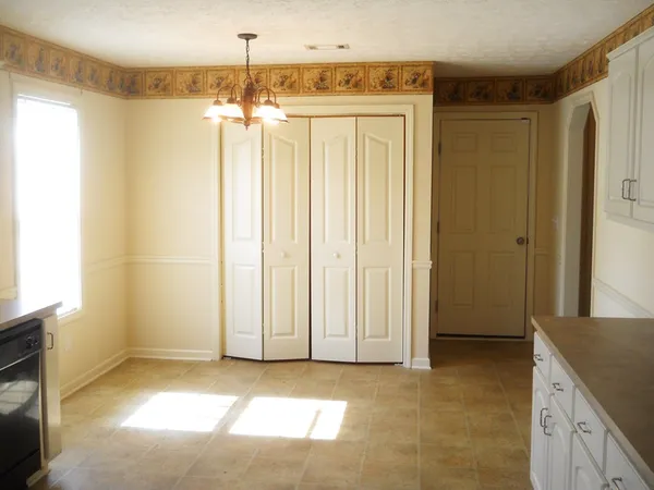 a view of a kitchen with a sink and cabinets