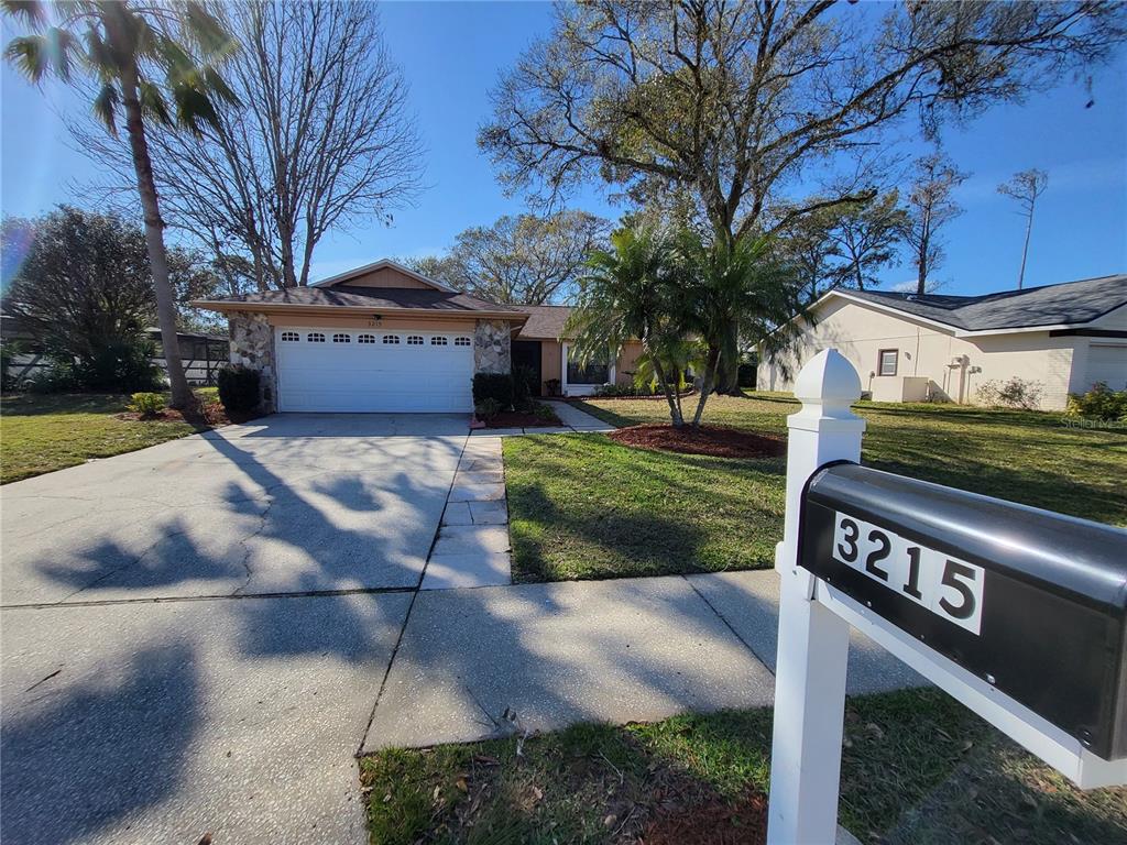 3215 Player Drive New Port Richey, FL 34655 - Photo 1 of 1 a view of a street with a building and a street sign