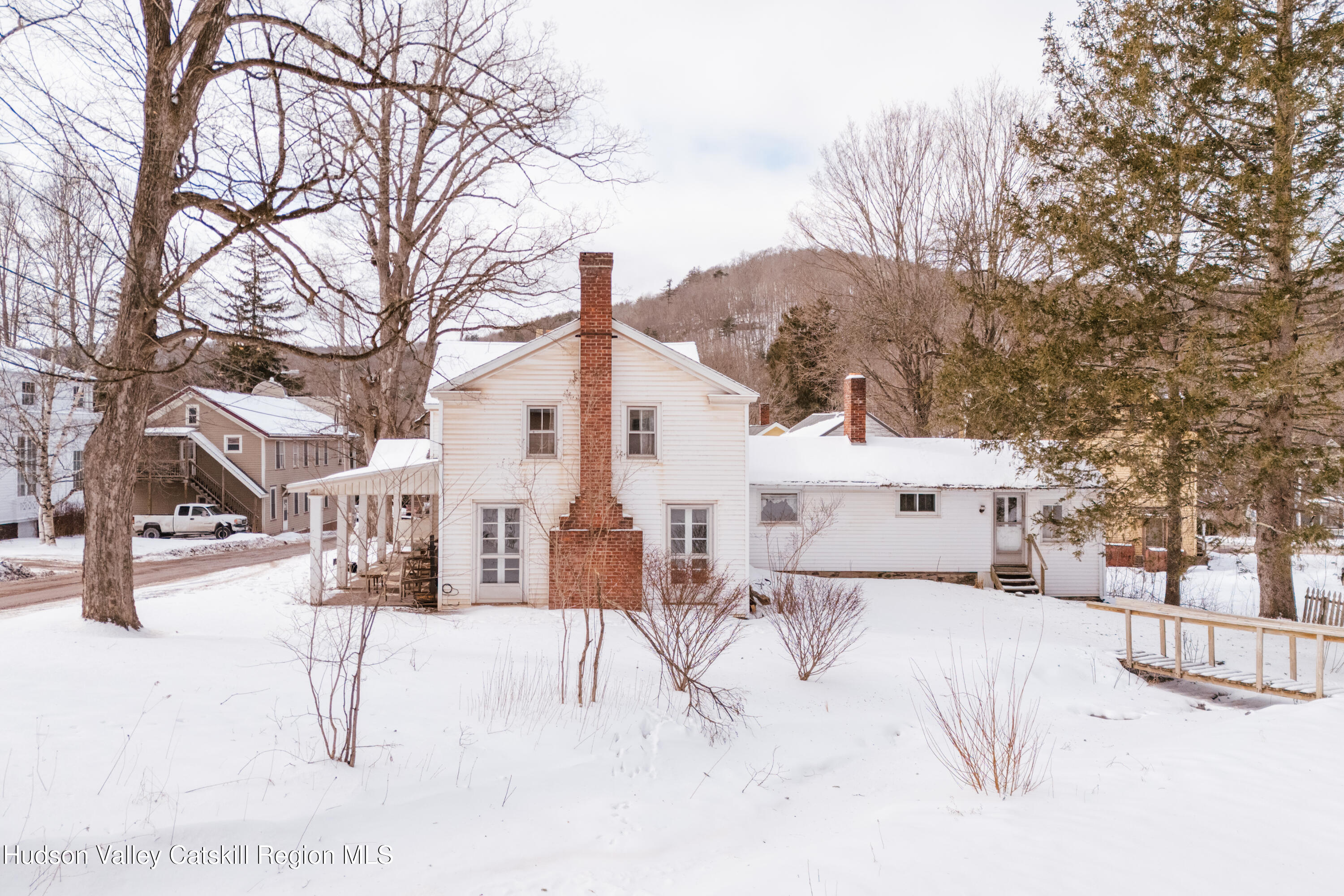 5020 Vega Mountain Road Roxbury, NY 12474 - Photo 5 of 31 a view of a white house with a snow