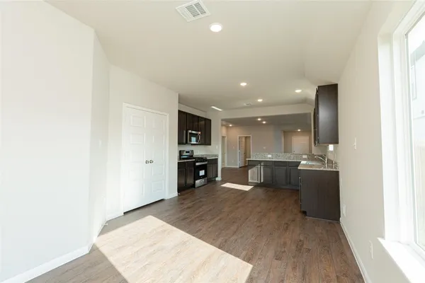 a view of kitchen with kitchen island microwave and stove