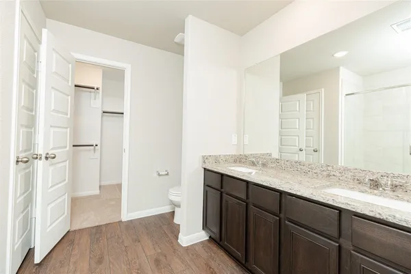 a bathroom with a granite countertop sink mirror and double