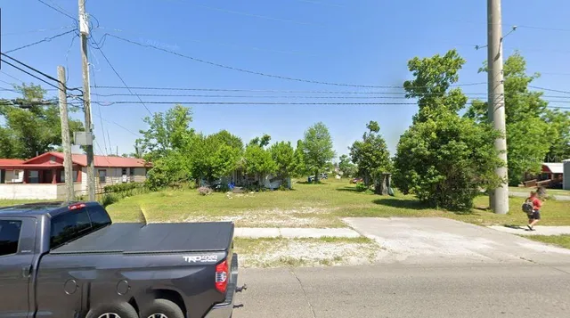 a yellow house with trees in front of it