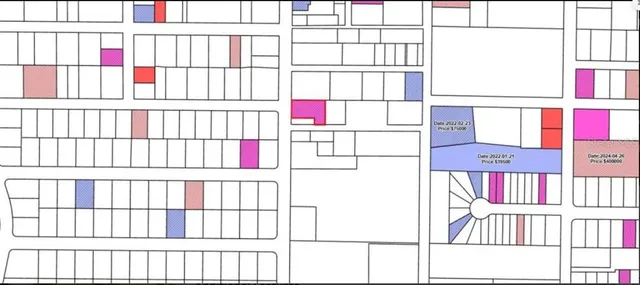 an aerial view of a houses with street