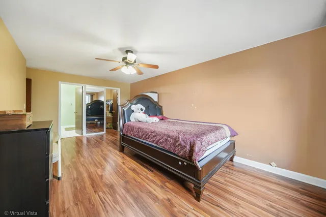 a bedroom with a bed a window and closet