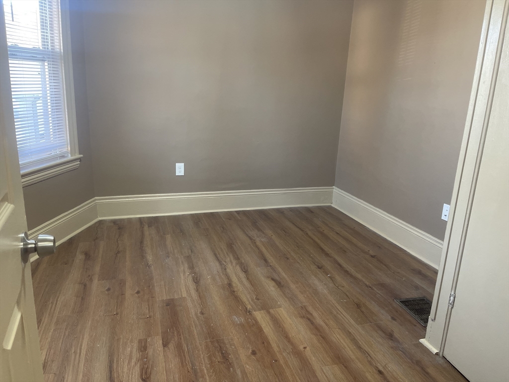 1002 River Street, Unit 2 Boston, MA 02136 - Photo 4 of 12 a view of a room with wooden floor and small window