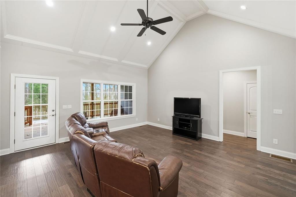 1006 Owens Store Road Canton, GA 30115 - Photo 7 of 48 a living room with furniture and a flat screen tv with wooden floor