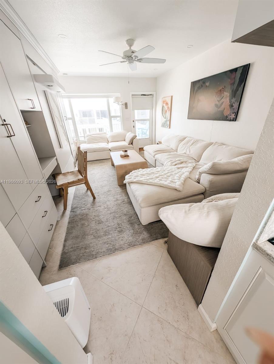1501 South Surf Road, Unit 21 Hollywood, FL 33019 - Photo 11 of 11 a living room with couches and a flat screen tv