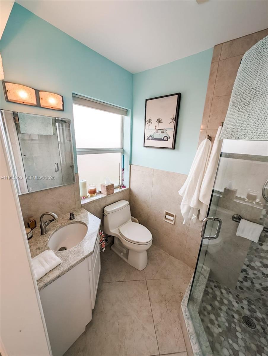 1501 South Surf Road, Unit 21 Hollywood, FL 33019 - Photo 4 of 11 a bathroom with a toilet sink and mirror