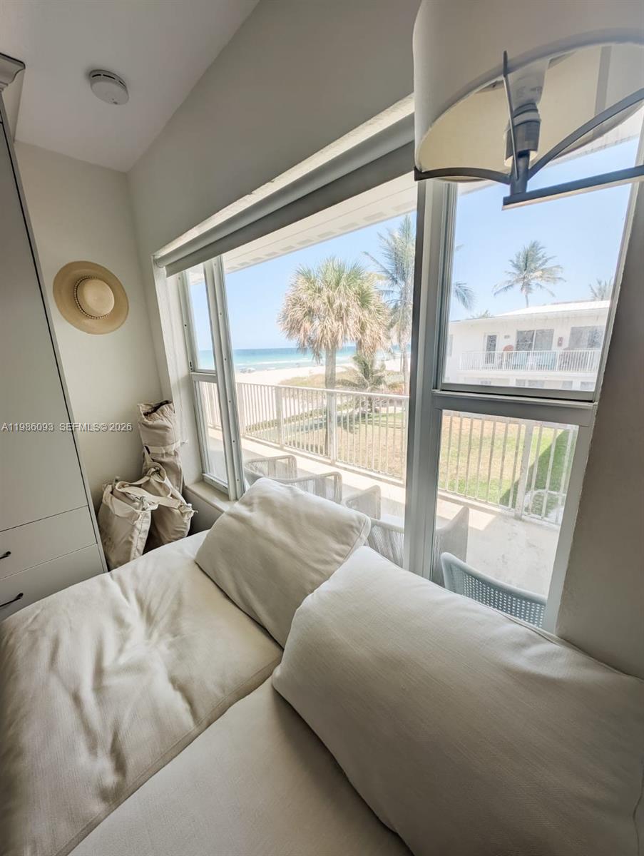 1501 South Surf Road, Unit 21 Hollywood, FL 33019 - Photo 9 of 11 a living room with furniture and a large window