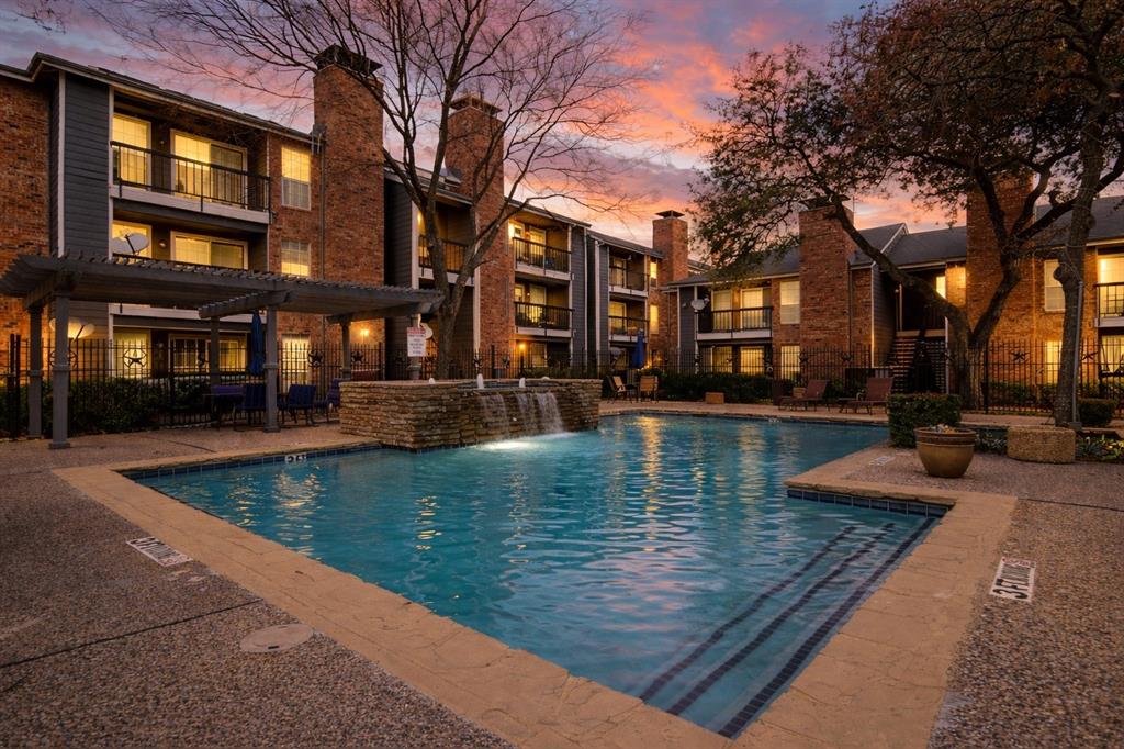 a view of pool with building and trees around