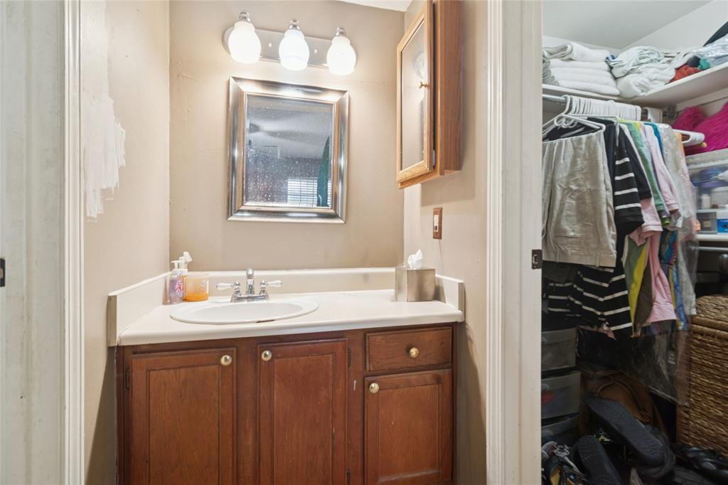18333 Roehampton Drive, Unit 224 Dallas, TX 75252 - Photo 12 of 24 a bathroom with a sink vanity and a mirror