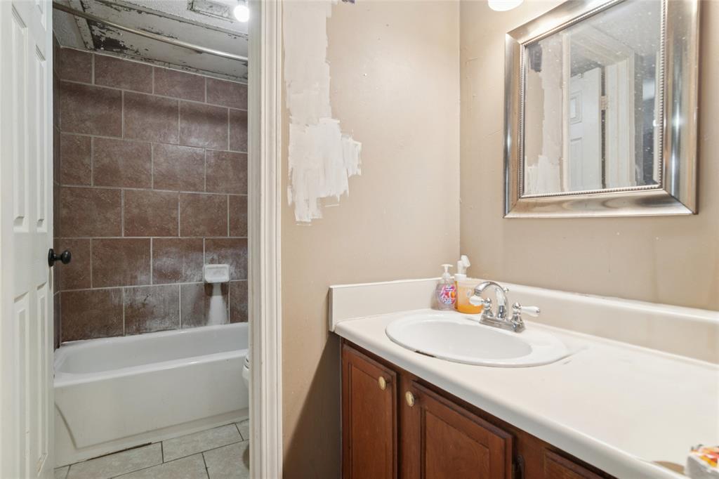 18333 Roehampton Drive, Unit 224 Dallas, TX 75252 - Photo 13 of 24 a bathroom with a sink and a mirror