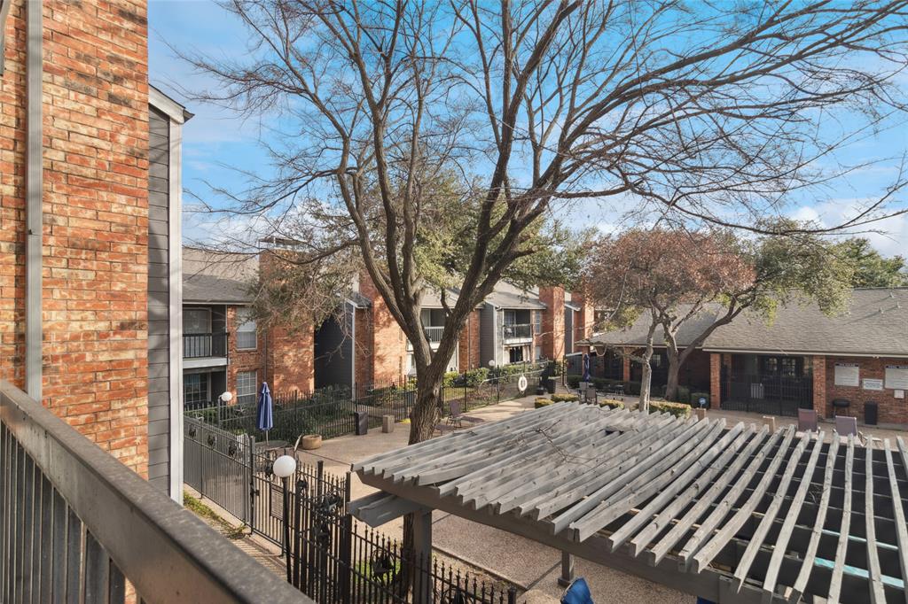 18333 Roehampton Drive, Unit 224 Dallas, TX 75252 - Photo 15 of 24 a view of a house with a yard covered in snow