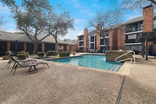 a view of a building with a yard and sitting area