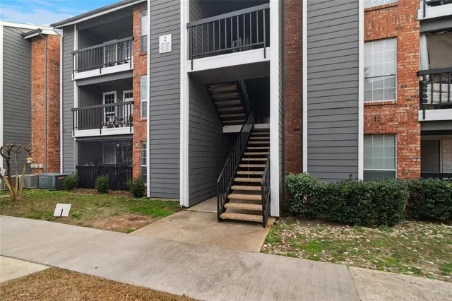 a view of a house with wooden door and a yard