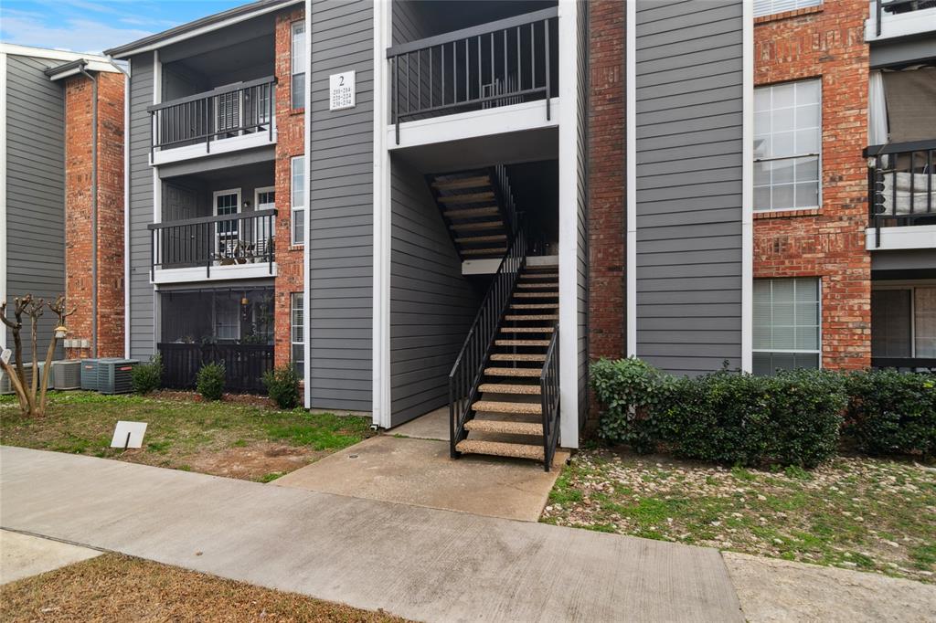 18333 Roehampton Drive, Unit 224 Dallas, TX 75252 - Photo 22 of 24 a view of a house with wooden door and a yard