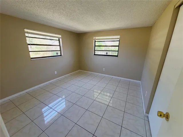 a view of an empty room with windows