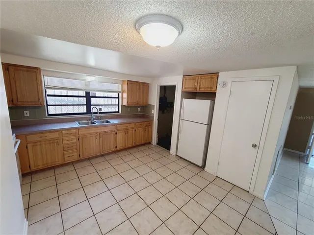 a kitchen with stainless steel appliances a sink and a refrigerator