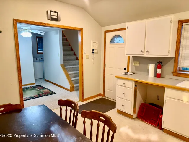 a kitchen with cabinets appliances and a counter