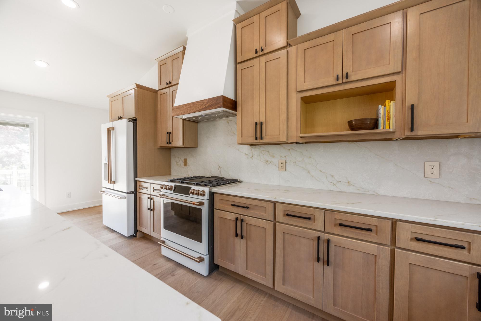 48 Mountainview Court Ewing, NJ 08628 - Photo 19 of 63 a kitchen with stainless steel appliances granite countertop white cabinets a microwave a stove and a refrigerator